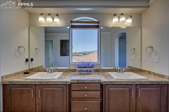 9444 Castle Oaks Dr, Fountain, CO 80817 - full bath with double vanity, crown molding, and a textured wall