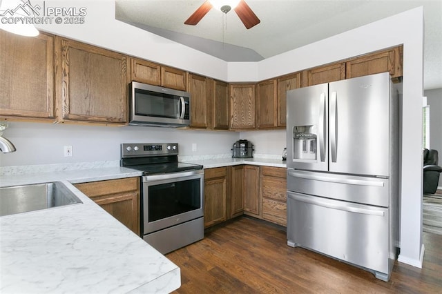 1360 Piros Dr, Colorado Springs, CO 80922 - kitchen with appliances with stainless steel finishes, light countertops, and brown cabinets