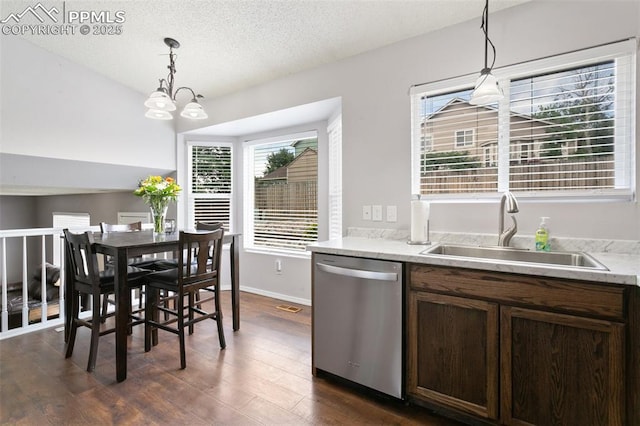 1360 Piros Dr, Colorado Springs, CO 80922 - kitchen with stainless steel dishwasher, dark wood finished floors, pendant lighting, dark brown cabinets, and a textured ceiling