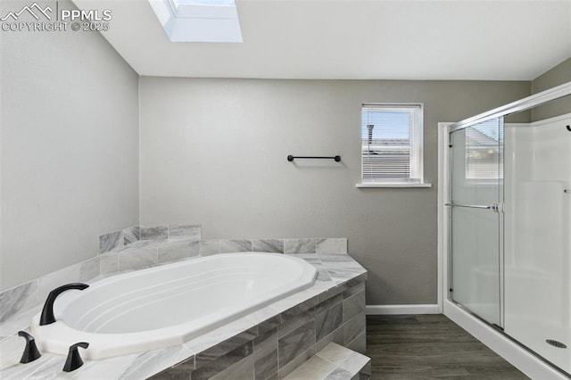 4680 Pika Pt, Colorado Springs, CO 80922 - bathroom featuring a garden tub, a shower stall, a skylight, and wood finished floors