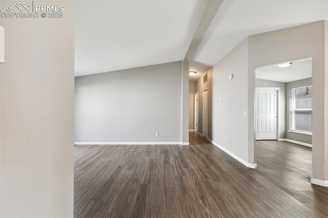 4680 Pika Pt, Colorado Springs, CO 80922 - unfurnished room featuring dark wood-style floors and vaulted ceiling