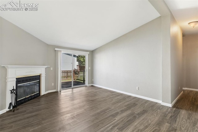 4680 Pika Pt, Colorado Springs, CO 80922 - unfurnished living room with dark wood-style floors and a glass covered fireplace