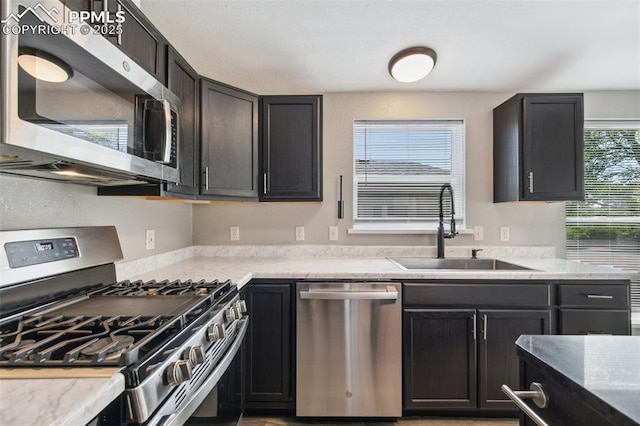 4680 Pika Pt, Colorado Springs, CO 80922 - kitchen featuring appliances with stainless steel finishes and light stone countertops