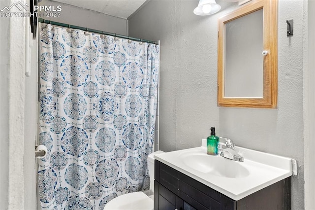 8991 Hickory Pl, Thornton, CO 80229 - full bathroom featuring vanity, a textured wall, and curtained shower