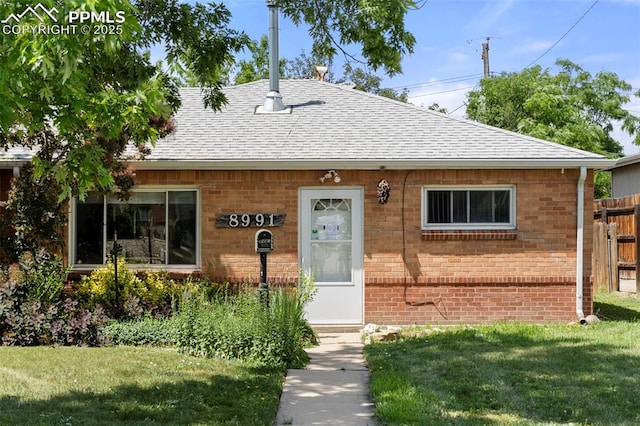 8991 Hickory Pl, Thornton, CO 80229 - bungalow-style house with a shingled roof and brick siding