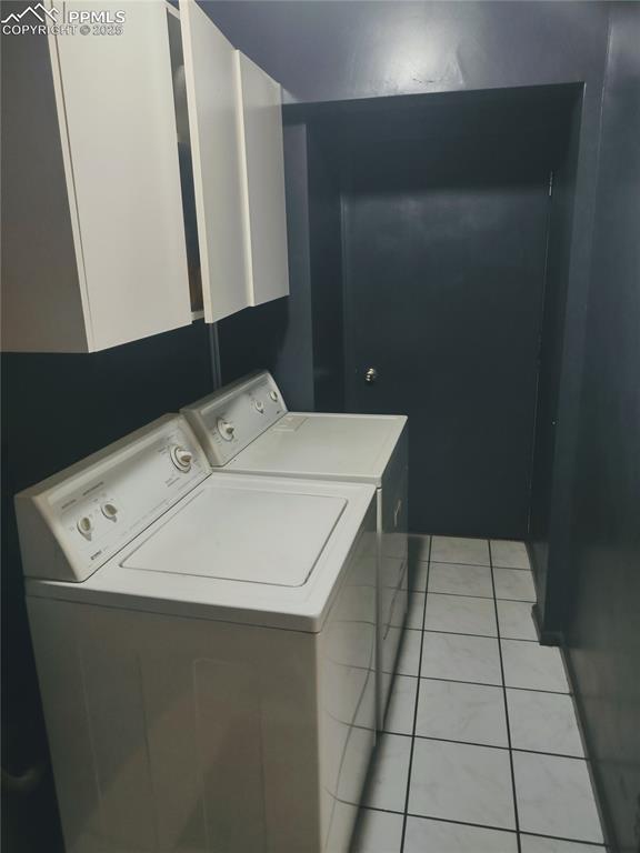 423 Ridge Rd, Divide, CO 80814 - laundry area featuring washing machine and dryer, cabinet space, and light tile patterned floors