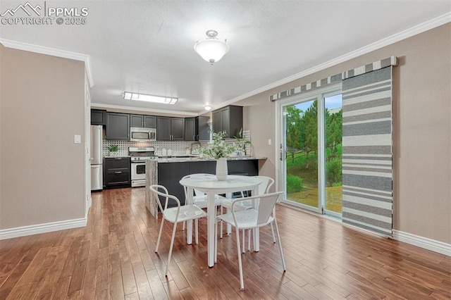 123 Wheat Ridge St, Palmer Lake, CO 80133 - dining room featuring ornamental molding and hardwood / wood-style flooring