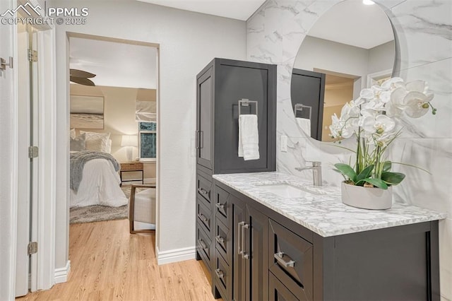 123 Wheat Ridge St, Palmer Lake, CO 80133 - bathroom featuring ensuite bathroom, wood finished floors, and vanity
