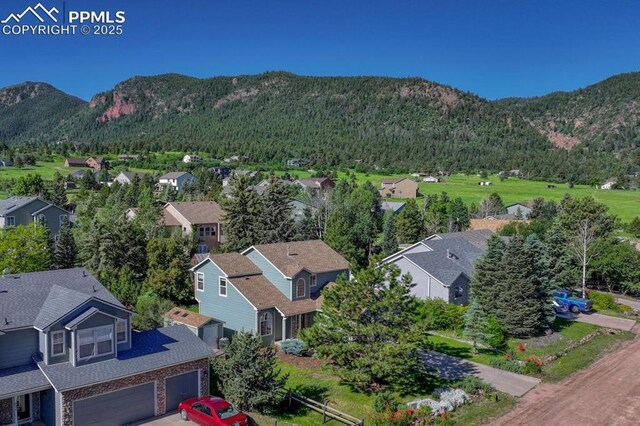 123 Wheat Ridge St, Palmer Lake, CO 80133 - aerial perspective of suburban area featuring a mountain backdrop
