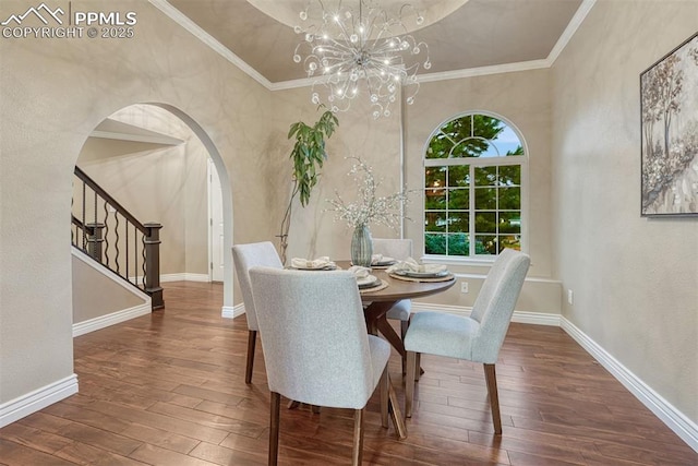 123 Wheat Ridge St, Palmer Lake, CO 80133 - dining area with hardwood / wood-style flooring, arched walkways, a chandelier, stairway, and a textured wall