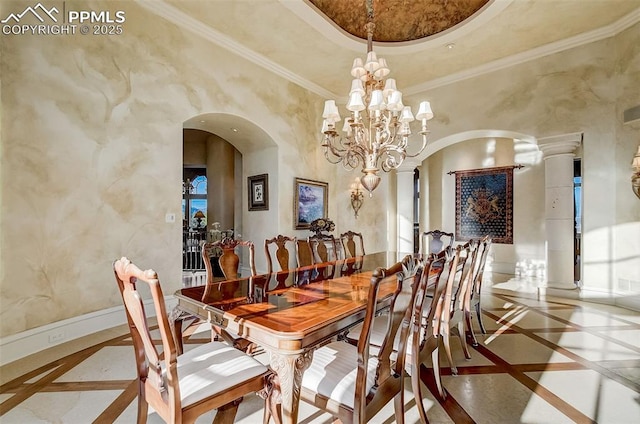910 Grey Mountain Pt, Colorado Springs, CO 80906 - dining space with inlaid floor details, arched walkways, a chandelier, and ornamental molding