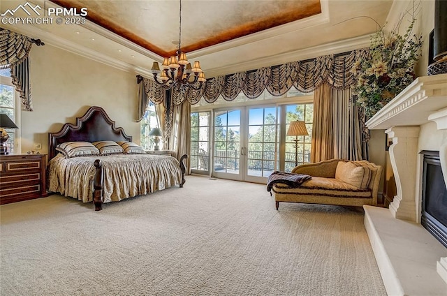 910 Grey Mountain Pt, Colorado Springs, CO 80906 - bedroom with a chandelier, access to exterior, a raised ceiling, ornamental molding, and carpet floors