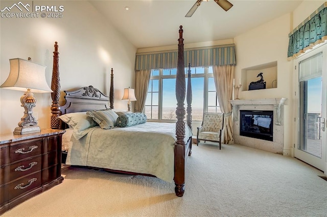 910 Grey Mountain Pt, Colorado Springs, CO 80906 - carpeted bedroom with vaulted ceiling, access to exterior, a fireplace, and a ceiling fan
