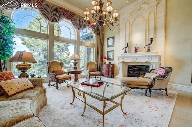 910 Grey Mountain Pt, Colorado Springs, CO 80906 - living room with ornamental molding, plenty of natural light, a chandelier, a glass covered fireplace, and a towering ceiling