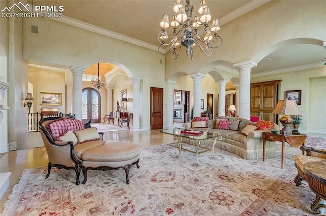 910 Grey Mountain Pt, Colorado Springs, CO 80906 - living room featuring arched walkways, tile patterned floors, crown molding, a high ceiling, and ornate columns