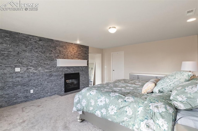 13437 Park Meadows Dr, Peyton, CO 80831 - bedroom with carpet, a glass covered fireplace, and recessed lighting