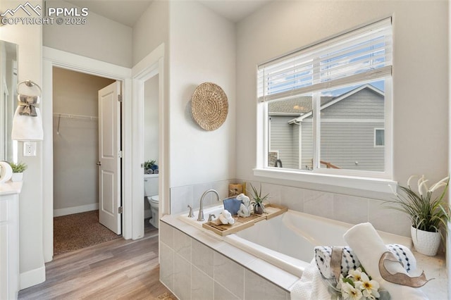 10238 Odin Dr, Colorado Springs, CO 80924 - full bath featuring a garden tub, wood finished floors, and a walk in closet