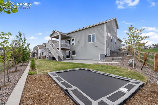 10238 Odin Dr, Colorado Springs, CO 80924 - rear view of house with stairs, a fenced backyard, a patio, a trampoline, and a deck