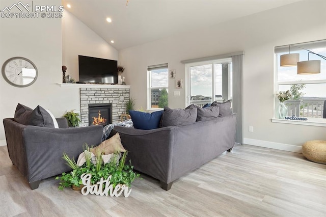 10238 Odin Dr, Colorado Springs, CO 80924 - living area with recessed lighting, wood finished floors, a fireplace, plenty of natural light, and high vaulted ceiling