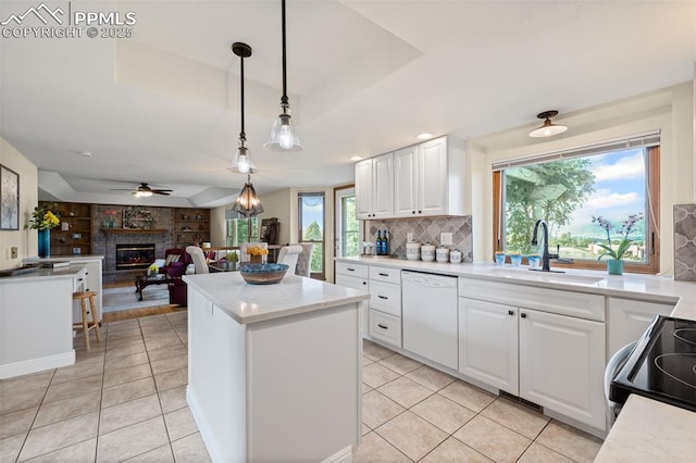 2505 Wimbleton Ct, Colorado Springs, CO 80920 - kitchen featuring dishwasher, electric stove, a brick fireplace, a kitchen island, and plenty of natural light