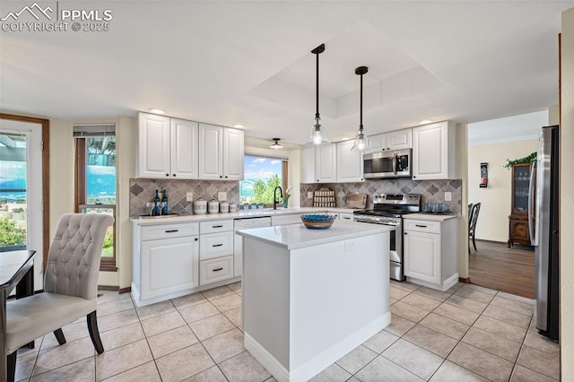 2505 Wimbleton Ct, Colorado Springs, CO 80920 - kitchen featuring appliances with stainless steel finishes, light tile patterned flooring, backsplash, light countertops, and white cabinetry