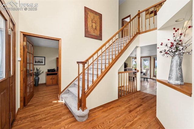 2505 Wimbleton Ct, Colorado Springs, CO 80920 - stairs featuring wood finished floors and a high ceiling