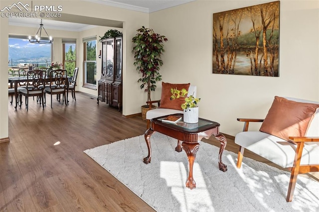 2505 Wimbleton Ct, Colorado Springs, CO 80920 - sitting room featuring crown molding, a chandelier, and wood finished floors