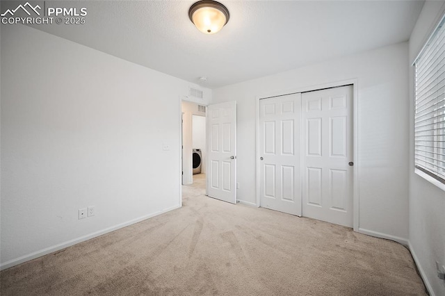 4867 Wolf Moon Dr, Colorado Springs, CO 80911 - unfurnished bedroom featuring carpet, washer / clothes dryer, and multiple windows