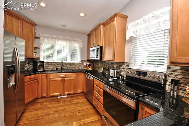 4201 Stonesthrow Vw, Colorado Springs, CO 80922 - kitchen featuring stainless steel appliances, light wood-style flooring, tasteful backsplash, open shelves, and recessed lighting