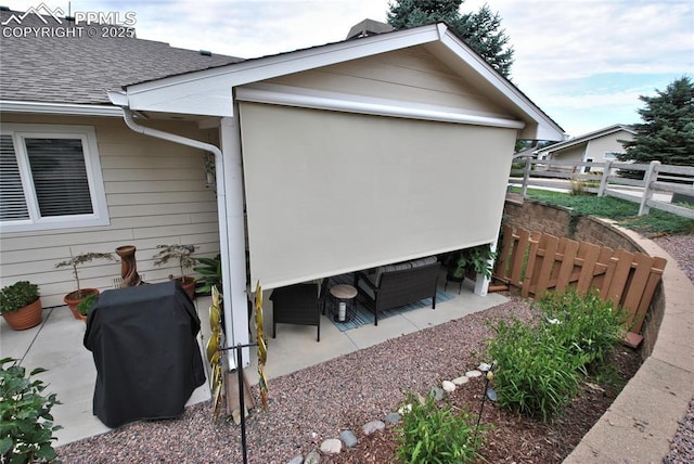 4201 Stonesthrow Vw, Colorado Springs, CO 80922 - view of side of property with a shingled roof and a patio area
