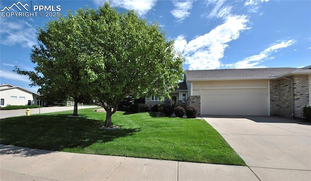 4201 Stonesthrow Vw, Colorado Springs, CO 80922 - view of front of house featuring brick siding, a garage, a front yard, and driveway