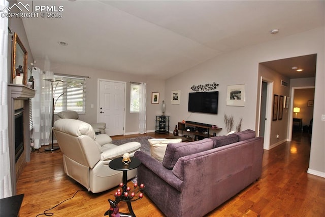 4201 Stonesthrow Vw, Colorado Springs, CO 80922 - living area featuring lofted ceiling, a fireplace, and wood finished floors