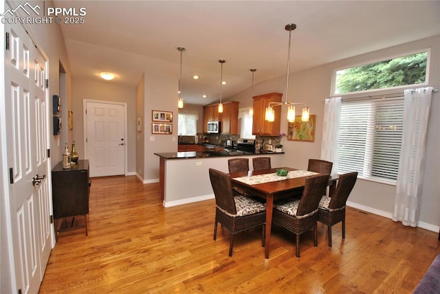 4201 Stonesthrow Vw, Colorado Springs, CO 80922 - dining area featuring light wood-style flooring and vaulted ceiling