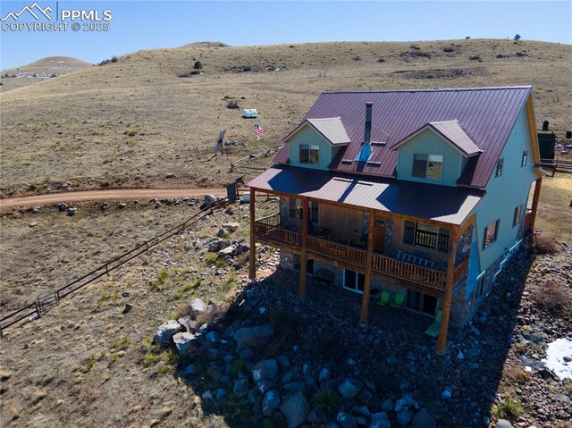 1160 Diamond Back Trl, Canon City, CO 81212 - rear view of house featuring a metal roof, a deck with mountain view, and a view of rural / pastoral area