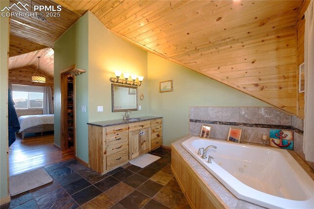 1160 Diamond Back Trl, Canon City, CO 81212 - ensuite bathroom featuring lofted ceiling, wood ceiling, a whirlpool tub, vanity, and stone tile flooring