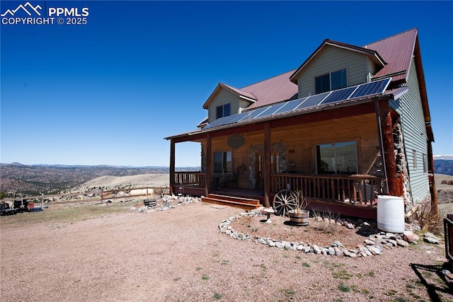 1160 Diamond Back Trl, Canon City, CO 81212 - view of front of property with a mountain view, a metal roof, and a porch