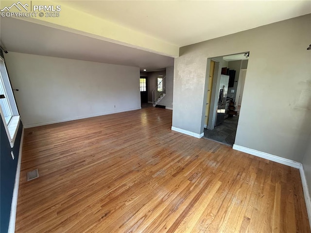 251 Fay Dr, Colorado Springs, CO 80911 - empty room with light wood-type flooring and stairway