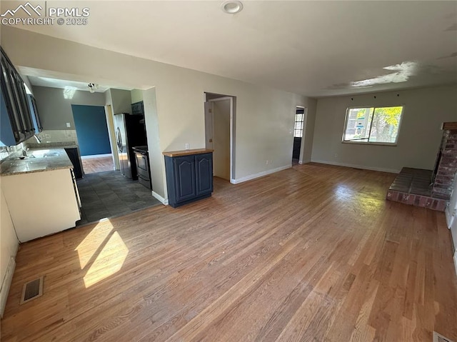 251 Fay Dr, Colorado Springs, CO 80911 - unfurnished living room featuring light wood finished floors and baseboards