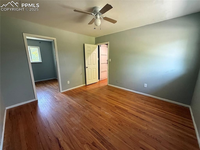 251 Fay Dr, Colorado Springs, CO 80911 - unfurnished bedroom featuring wood finished floors, a spacious closet, and a ceiling fan