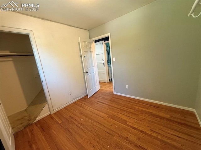 251 Fay Dr, Colorado Springs, CO 80911 - unfurnished bedroom featuring wood finished floors and a closet