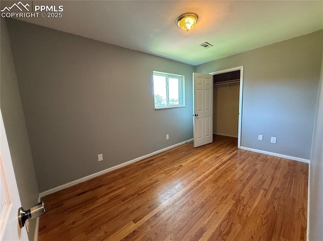 251 Fay Dr, Colorado Springs, CO 80911 - unfurnished bedroom with wood finished floors and a closet
