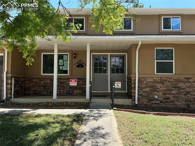 251 Fay Dr, Colorado Springs, CO 80911 - entrance to property featuring stone siding, stucco siding, and a porch