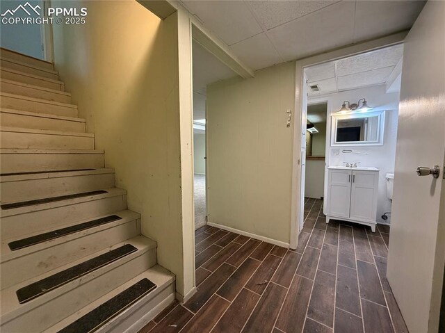 251 Fay Dr, Colorado Springs, CO 80911 - staircase featuring wood finished floors and a paneled ceiling