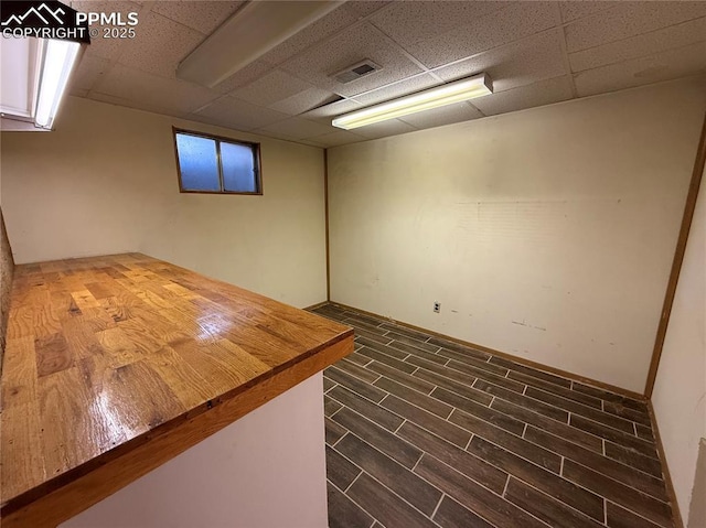251 Fay Dr, Colorado Springs, CO 80911 - finished basement featuring a drop ceiling and dark wood finished floors