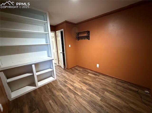 251 Fay Dr, Colorado Springs, CO 80911 - spare room with dark wood-type flooring and crown molding