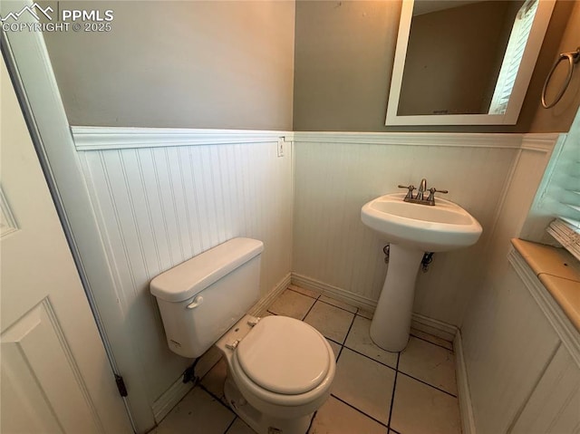 251 Fay Dr, Colorado Springs, CO 80911 - bathroom with wainscoting and tile patterned flooring