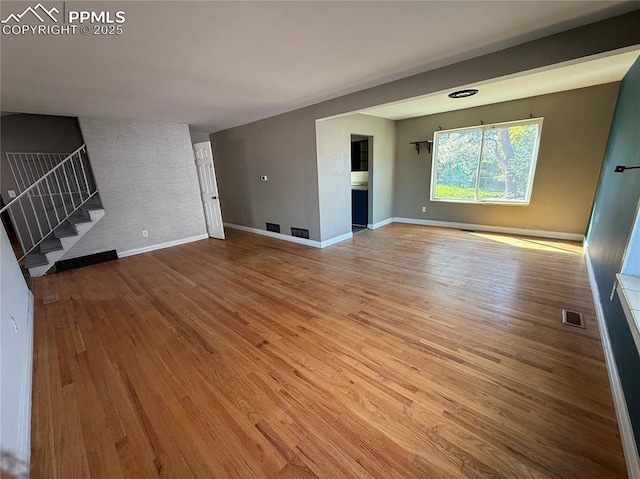 251 Fay Dr, Colorado Springs, CO 80911 - unfurnished living room with stairs and wood finished floors