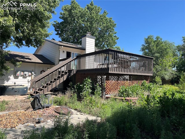 4095 Candea Ct, Colorado Springs, CO 80916 - rear view of house featuring stairway, a deck, and a chimney