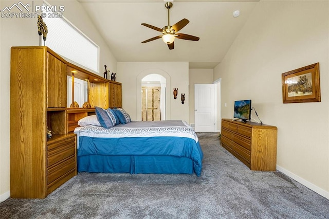 2997 Bright Moon Dr, Colorado Springs, CO 80908 - carpeted bedroom featuring arched walkways, vaulted ceiling, ceiling fan, and ensuite bath