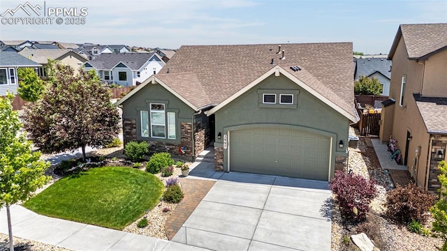 2997 Bright Moon Dr, Colorado Springs, CO 80908 - view of front facade with stucco siding, driveway, roof with shingles, and stone siding